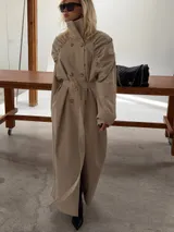 Leather trench recommended to pair with the pink jumper Model wearing a Leather trench